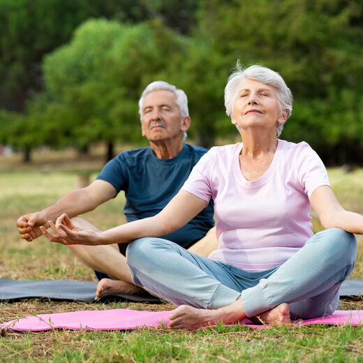 Mann und Frau machen Yoga im Freien