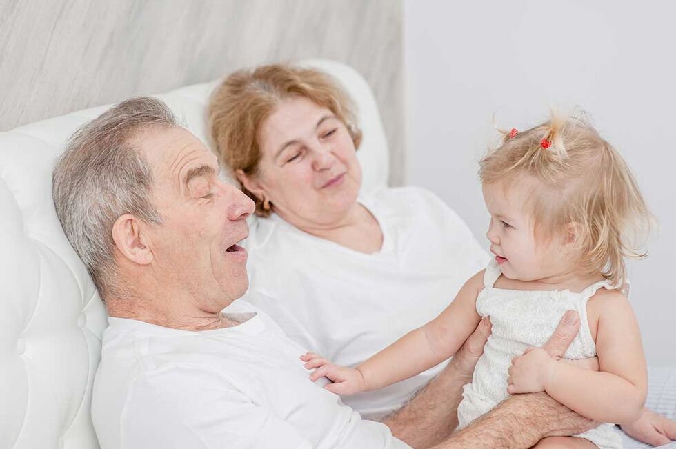 Versicherung für Rentner: Opa und Oma mit Enkelkind