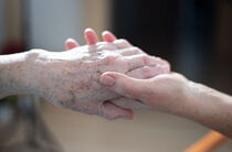 Ambulante Pflege reicht die Hand Eine ältere Person und eine junge Person geben sich die Hand